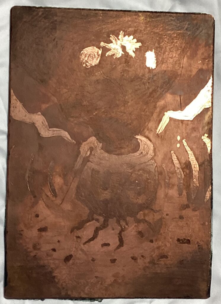 1: An image etched onto a plate of copper. Although hard to make out, it is supposed to be a cauldron with the letters CU emblazoned on it along with the number 29. Within the cauldron is a spool of wires wound around something containing bubbling molten metal releasing smoke. From this pool something that resembles a cross between a tree and wires is sprouting out, at the end of which are various forms of electronics. Leaning on the cauldron is a pickaxe and at the bottom of the cauldron there is a crack from which molten metal resembling the shape of roots leaks into the ground, or metal ore being sucked into the cauldron from the ore in the stratified ground. On either side of the cauldron there are waves resembling depictions of signals radiating outward. In the background there are poles holding up power cables.
