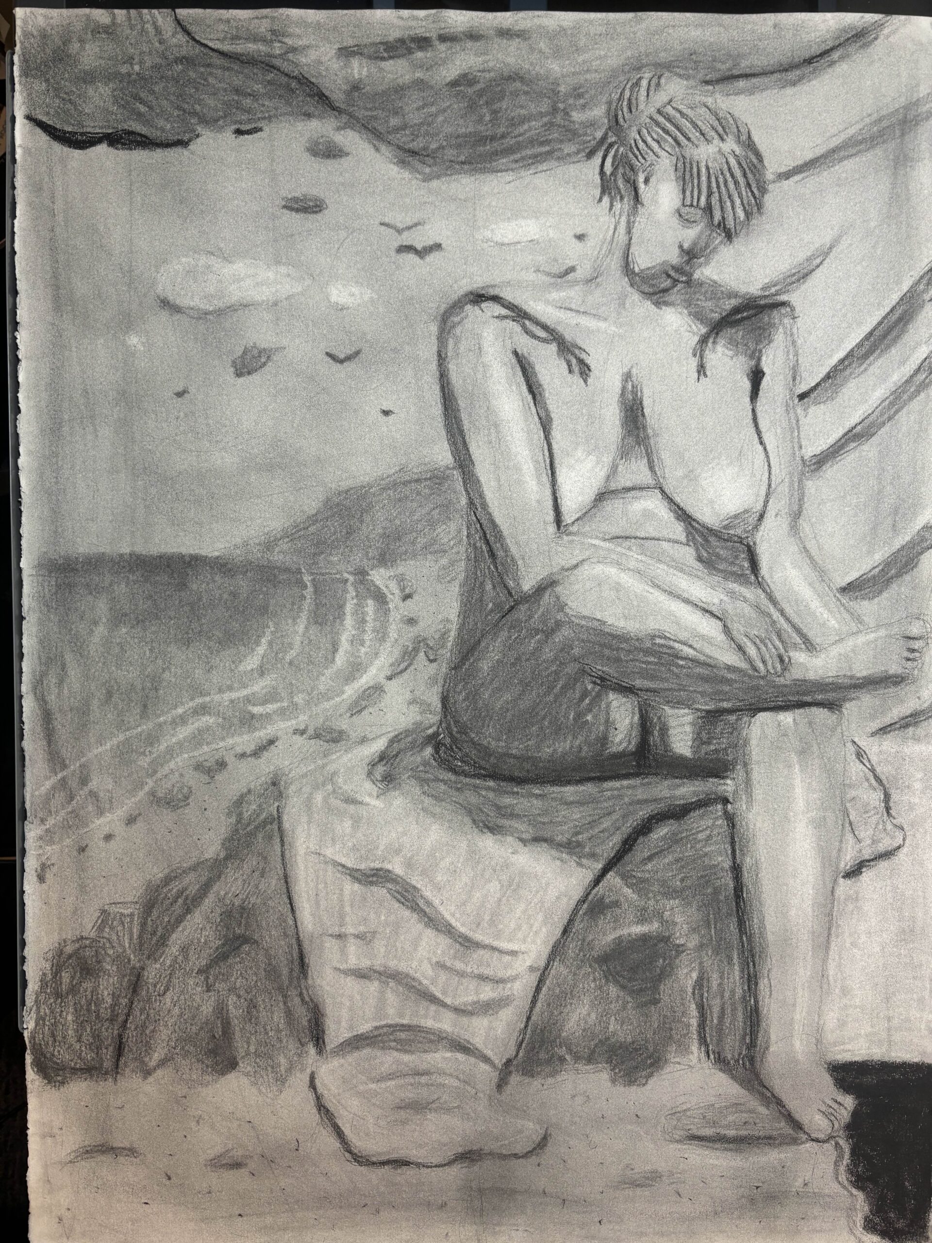 A drawing of a Black woman sitting on a rock with a blanket partially draped over it. To the left of the figure is a beachside and to her right is the inside of a studio with a blanket draped from the wall. The figure has tattoos on each of her shoulders pointing and curving down towards her chest. They resemble fire and / or branches. The woman is looking down at an angle with her right foot on her left knee and her right hand on top of the right foot.