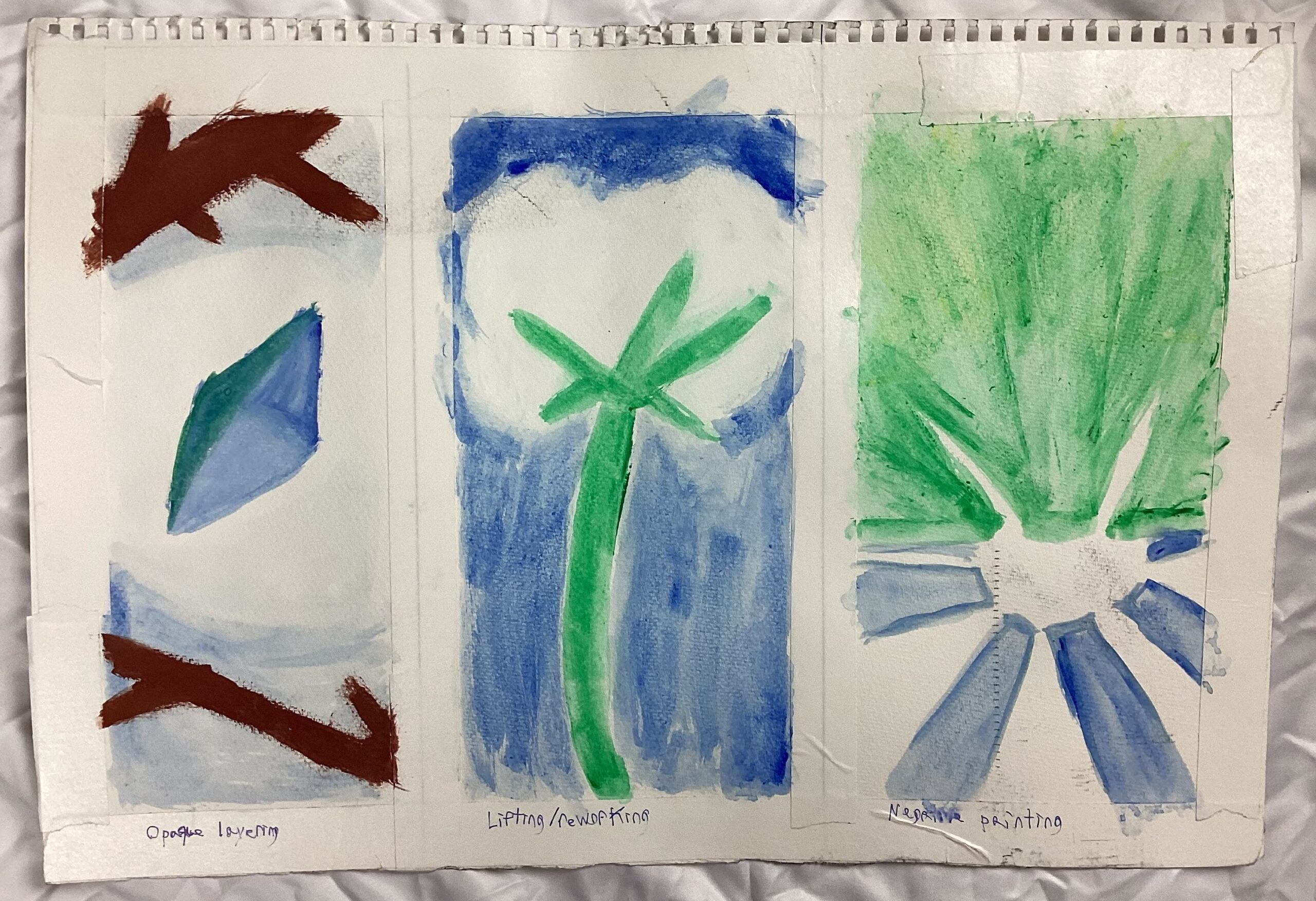 1: A torn piece of paper that is trisected into 3 “frames” by masking tape. The leftmost painting is a blue gem with a diamond cut between two branches. Around it there is an area with no paint which, thanks to the white paper, gives the illusion of a glowing effect against the blue background within the picture. The center image depicts a cotton plant. While the stem and sky are depicted using green and blue paint respectively, the cotton of the plant is rendered using the white space of the paper (by leaving the area blank). The rightmost drawing is upside down but depicts a sun rising over a green landscape in a blue sky. The sun’s shape is implied by simply using the white of the paper to create a shape with no paint.